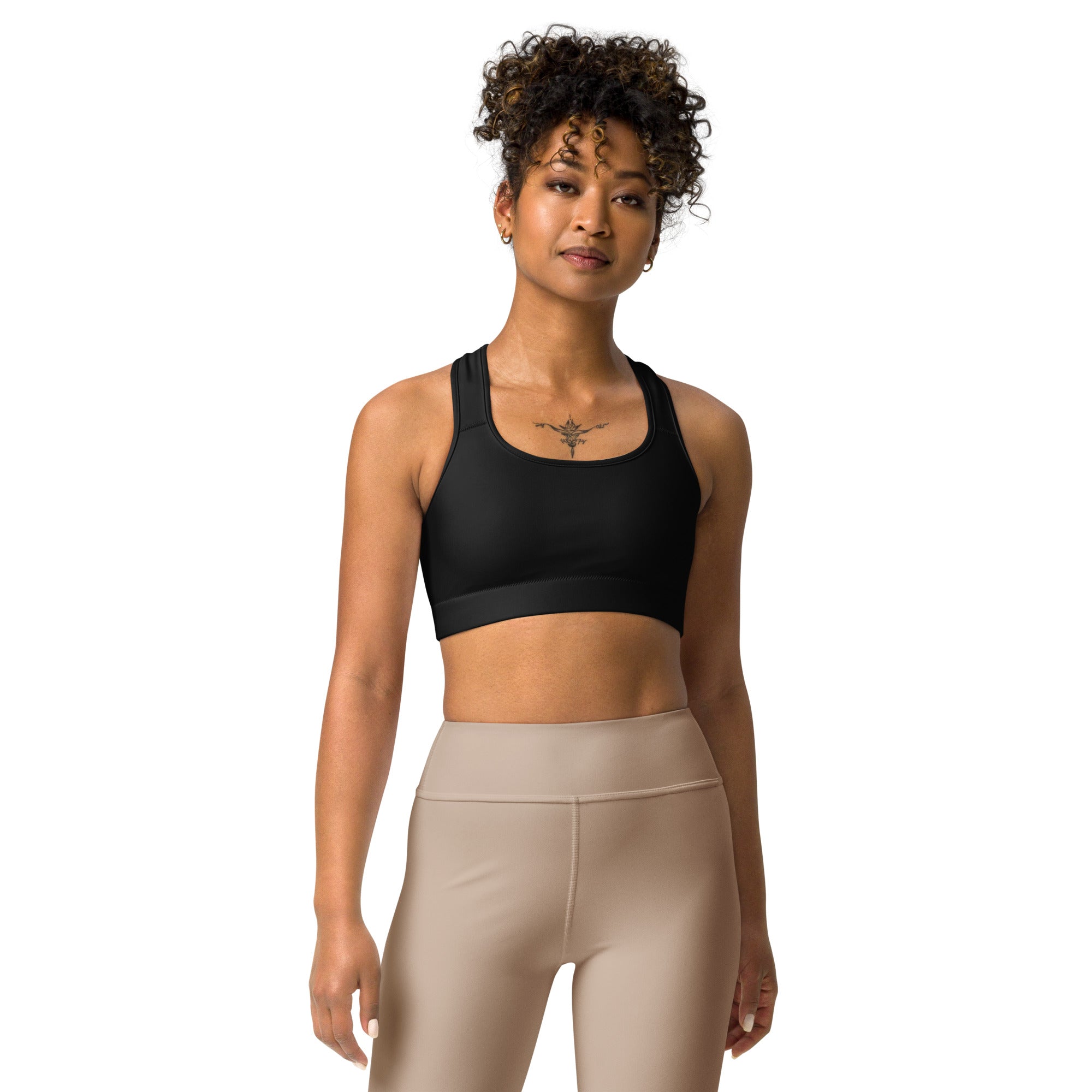 a woman wearing a Sweetest Paw Sports Bra Black top and beige leggings.