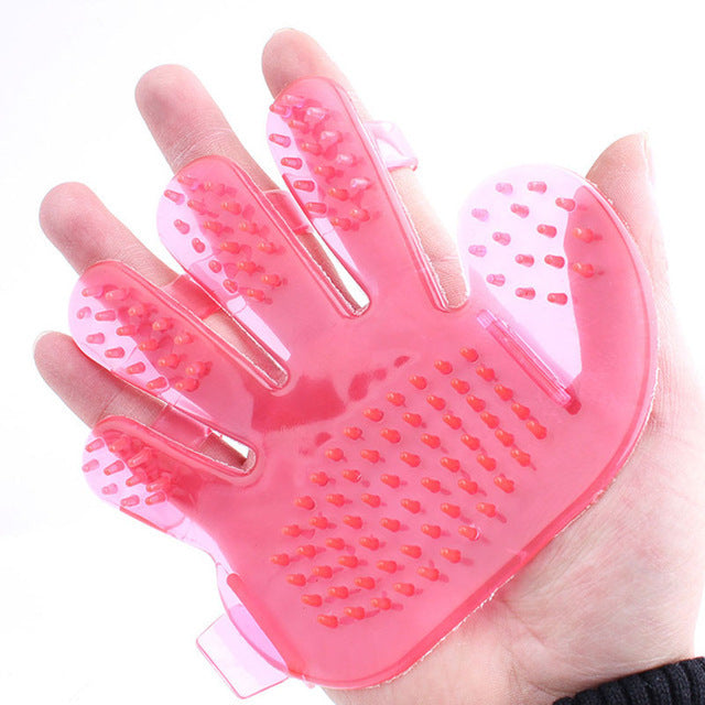 a person holding a Sweetest Paw pink Pet Grooming Brush Glove.