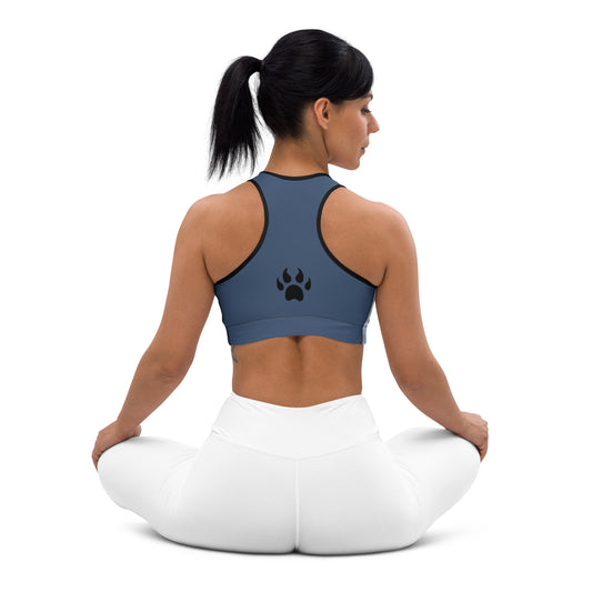 A woman sitting in a yoga pose with a paw print on her Sweetest Paw Padded Sports Bra Stripe.