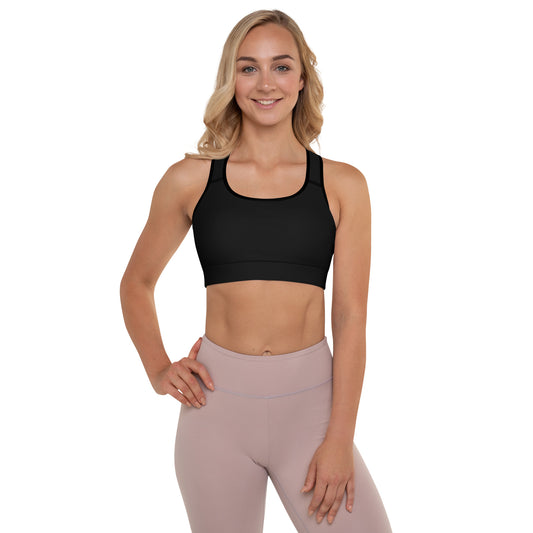 A woman wearing a Sweetest Paw Padded Sports Bra Black top and pink leggings.