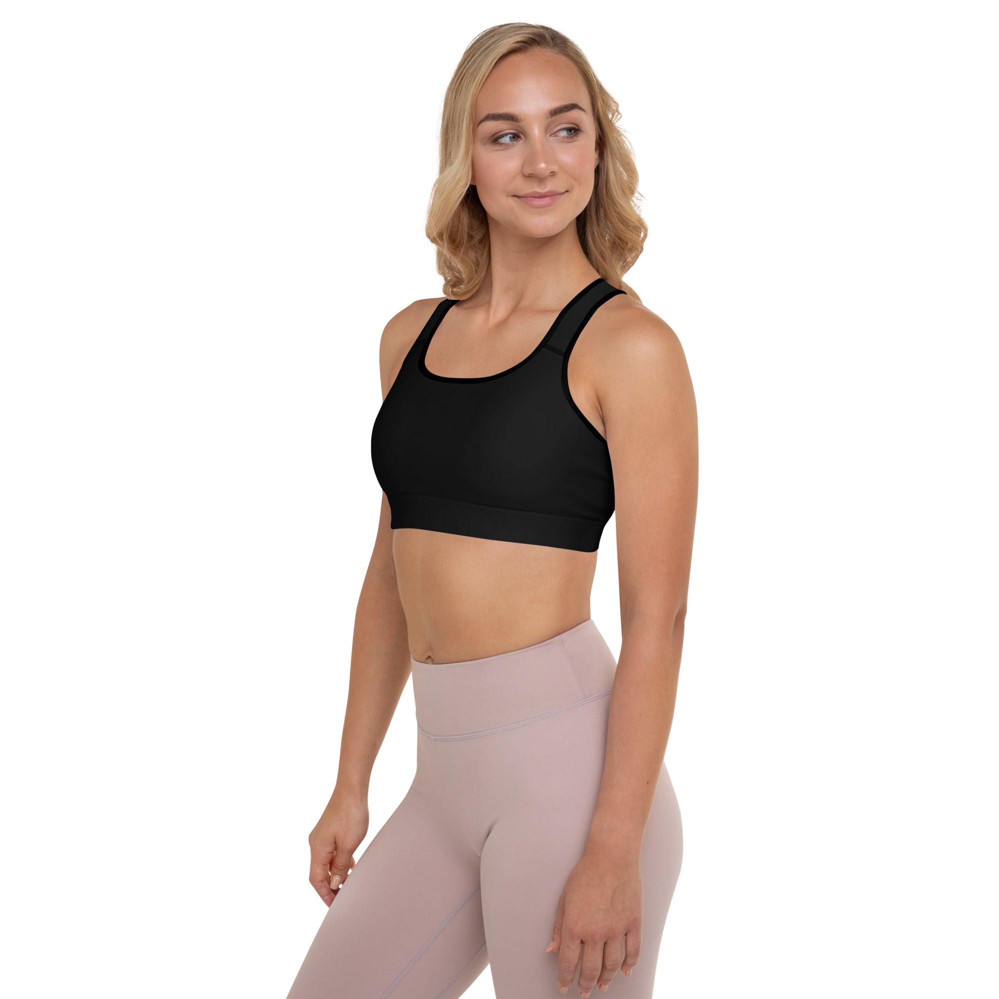 a woman wearing a Sweetest Paw Padded Sports Bra Black top and pink leggings.