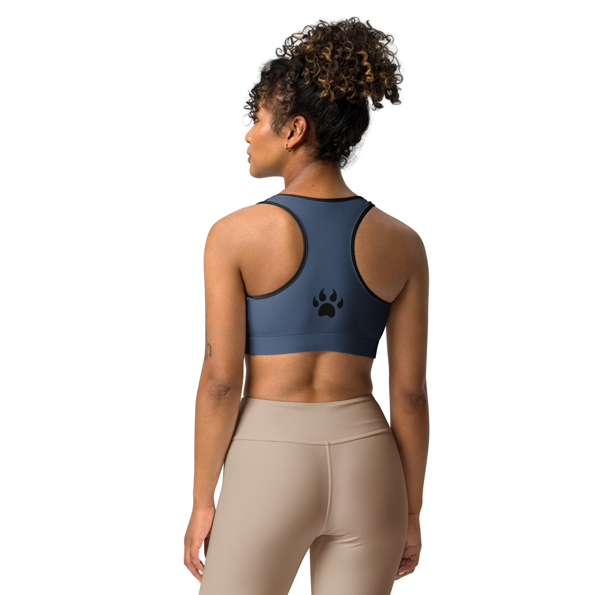 The back view of a woman wearing a blue Sweetest Paw Sports Bra Camo with paw print.