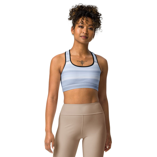 a woman wearing a blue and tan Sweetest Paw Sports Bra Stripes top.