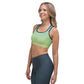A woman wearing a green and blue Sweetest Paw Sports Bra Multi top.