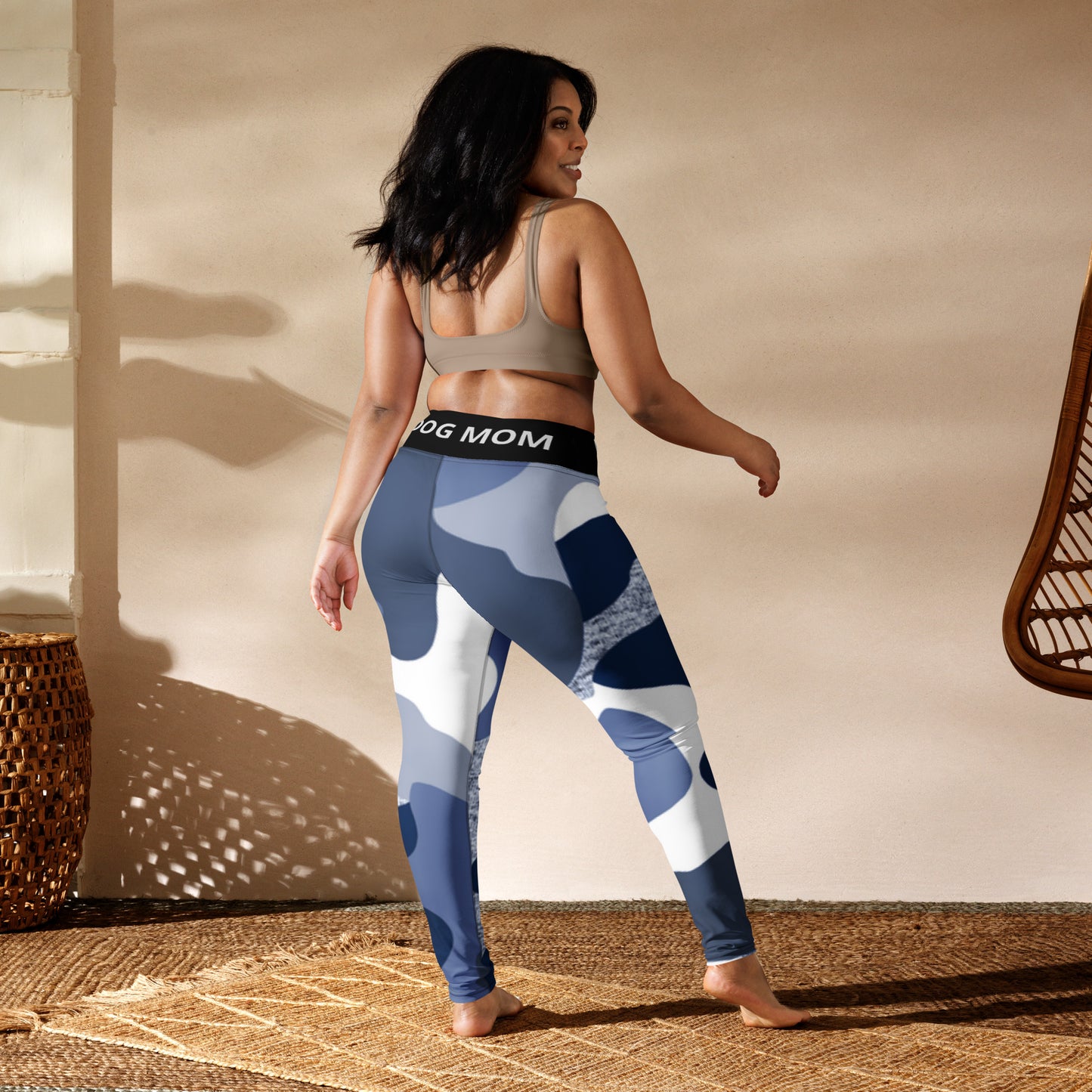 The back of a woman wearing Sweetest Paw blue and white camouflage Yoga Leggings Camo.