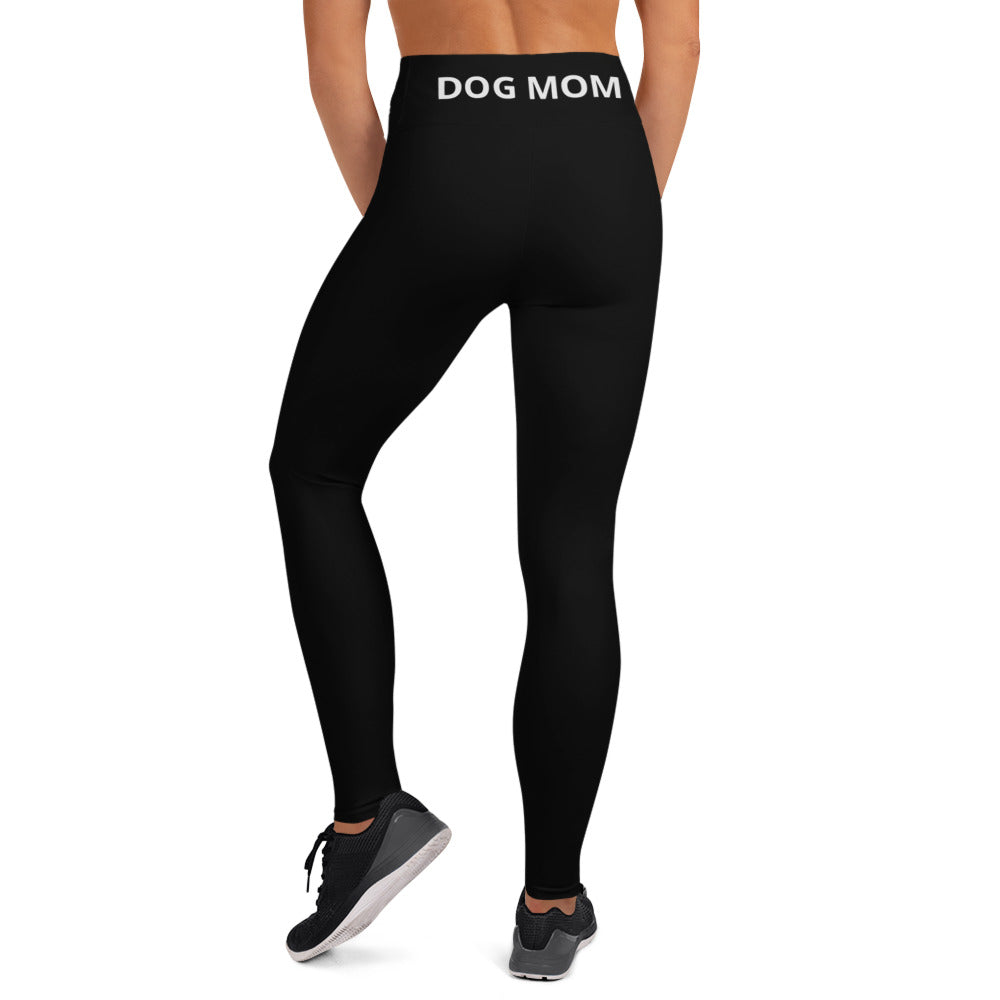 A woman wearing Sweetest Paw's Yoga Leggings Black with the word dog mom on them.