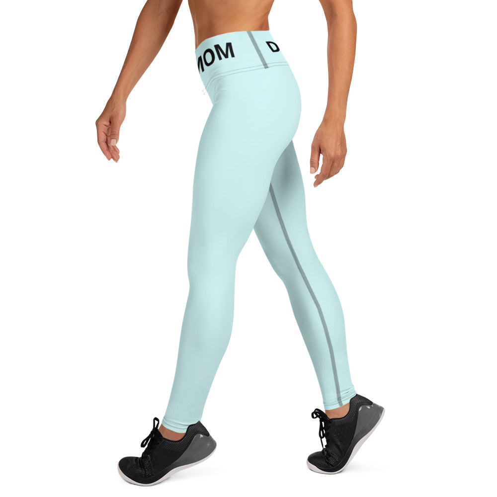 The back view of a woman wearing Sweetest Paw Yoga Leggings Teal with the word mom on them.