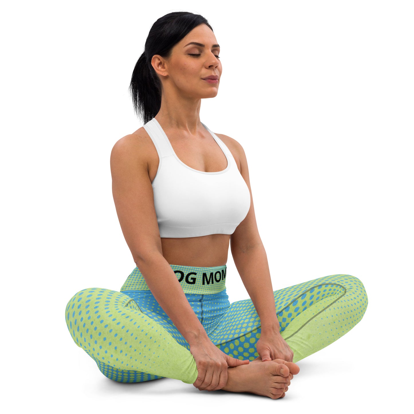 A woman is sitting in a Sweetest Paw Yoga Leggings Multi.