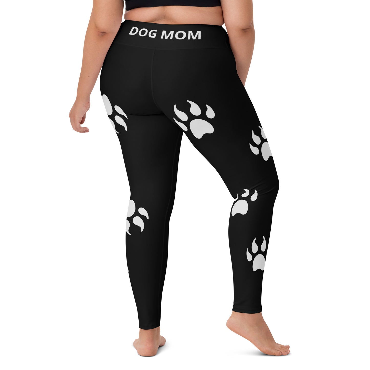 A woman wearing Sweetest Paw's Yoga Leggings Black PawPrint with dog paw prints.