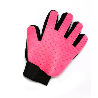 a Sweetest Paw Pet Grooming Brush Glove with black dots on it.