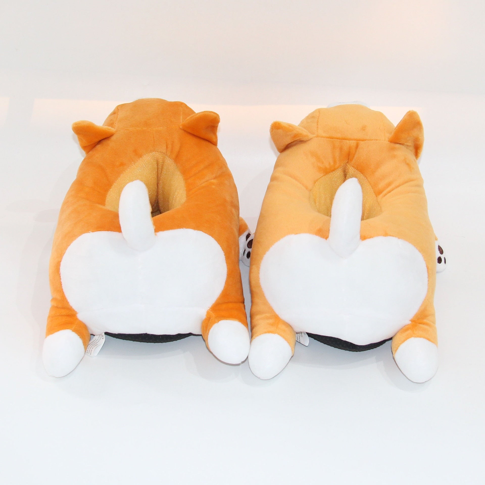 a pair of Sweetest Paw Cute Shiba Inu Dog Slippers on a white surface.
