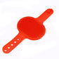 a Sweetest Paw red plastic Pet Grooming Brush Glove on a white surface.